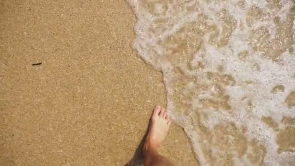 Mens benen op het zand van de zee en de Golf, ontspanning op de oceaan strand, zomervakantie. — Stockvideo