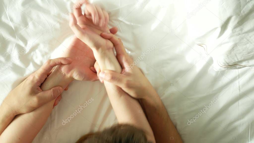 Hands of couple making love. Man and woman having sex. top view