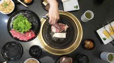 Korece Barbekü ızgara. aşçı insanlar ve bir restoranda Kore bir ızgarada pişmiş yemekler yiyin. yakın çekim.