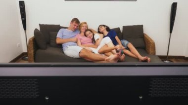 Büyüleyici aile, Anne, Baba, kızı ve oğlu oturma odasında birlikte Tv izliyor musun