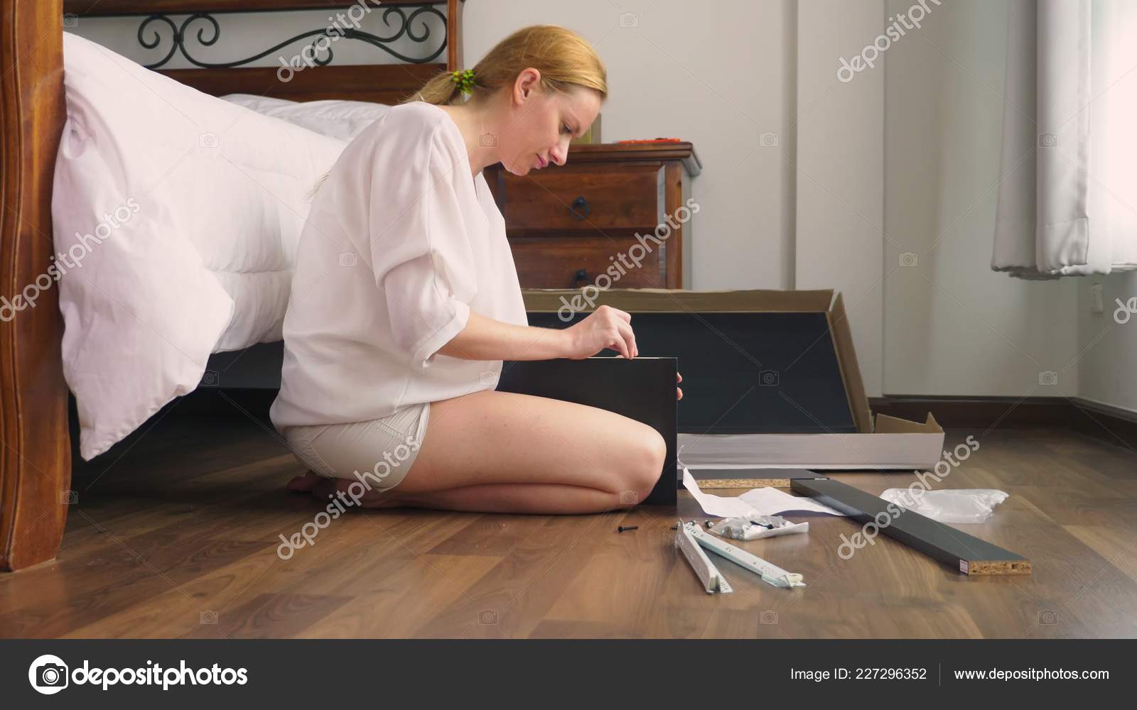 Assembling Furniture At Home A Housewife Assembles