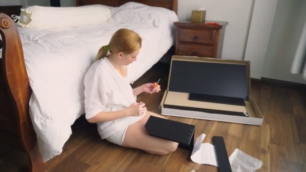 Assembling furniture at home, a housewife assembles a computer desk using hand tools. — Stock Video