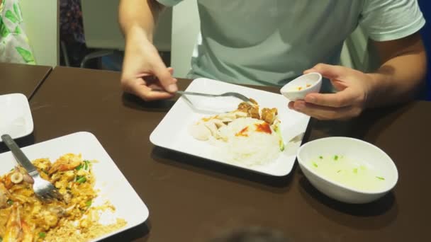 Närbild. någon äter en maträtt av asiatisk mat på en restaurang. — Stockvideo