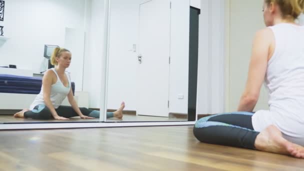 Femme s'étirant près du miroir à son appartement. Le concept d'un mode de vie sain, pas un sport professionnel . — Video