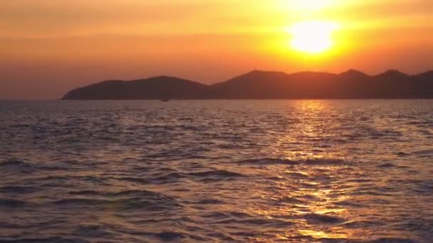 Вид з моря на острів під час заходу сонця, моря — стокове відео