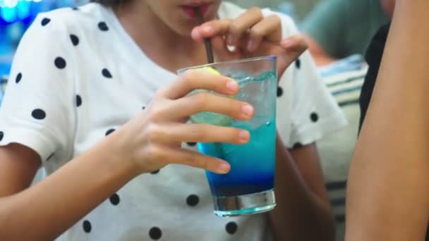 Close-up. girl in a cafe drinking a cocktail through a straw. drinks, people and lifestyle — Stock Video