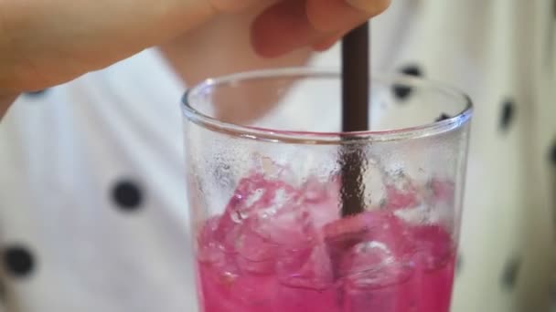 Close-up. girl in a cafe drinking a cocktail through a straw. drinks, people and lifestyle — Stock Video