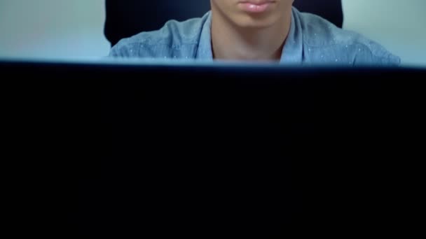 Jovem bonito asiático homem usando seu laptop, sentado na mesa no escritório — Vídeo de Stock