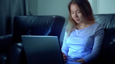 şirin Asyalı kadın geceleri dizüstü bilgisayar kullanmak