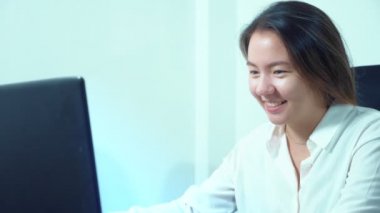 şirin Asyalı kız masa ofis dizüstü bilgisayar kullanmak