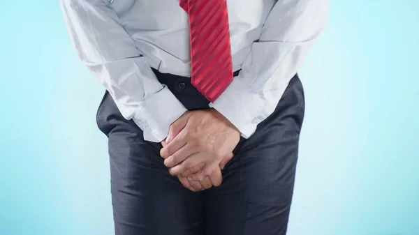 A person has problems with the genitourinary system. businessman on a colored background. close-up — Stock Photo, Image