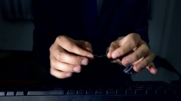 Close-up, hands of a businessman working on a computer keyboard in handcuffs. concept of cyber crime, workaholism — Stock Video