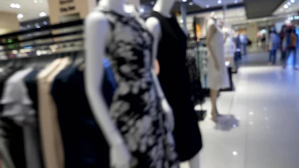 Blurred background. inside a large modern womens clothing store. — Stock Photo, Image