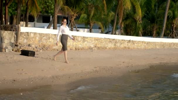 Happy Business vrouw in pak en donkere glazen is spatten in de zee op luxe resorts. Het concept van een langverwachte vakantie, freelancen. — Stockvideo