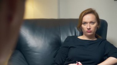 genel kavram-in müzakere, psikolojik danışmanlık. Bir kadın bir defter ile başarılı bir adam ile iletişim kurar. akşam bir deri sandalye ofisinde oturuyor.