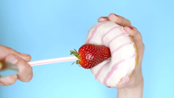 The concept of a healthy diet and diet. Strawberries and white pink donut. Fun fast food project — Stock Video