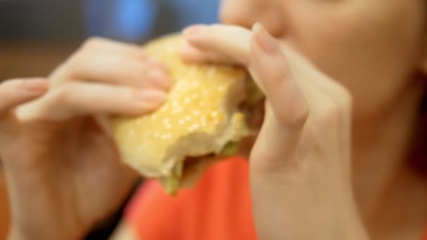 Για να κλείσει. γυναίκα με έρπη στο χείλος της τρώει τηγανητές πατάτες και χάμπουργκερ — Αρχείο Βίντεο