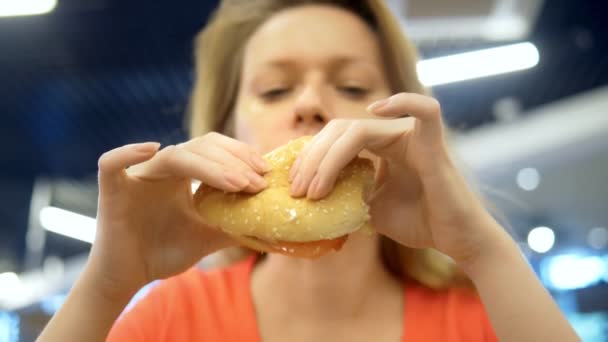Για να κλείσει. γυναίκα με έρπη στο χείλος της τρώει τηγανητές πατάτες και χάμπουργκερ — Αρχείο Βίντεο