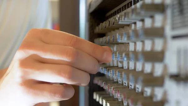 close-up. Hand Turns the pan knob on the sound mixer