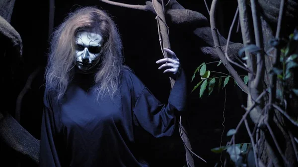 Concept of horror, ghost woman in the forest. Beautiful woman with make-up skeleton in a scary forest. — Stock Photo, Image