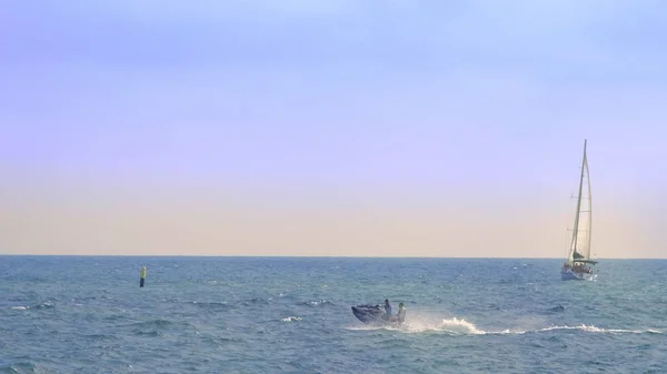 Concepto de deportes acuáticos, diversión de verano. barcos y veleros en el mar . — Foto de Stock