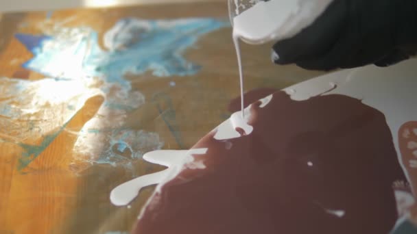 Verkstad av flytande akryl. Fluid art. kvinnliga händer hälla akrylfärg på duk. Kreativt arbete — Stockvideo