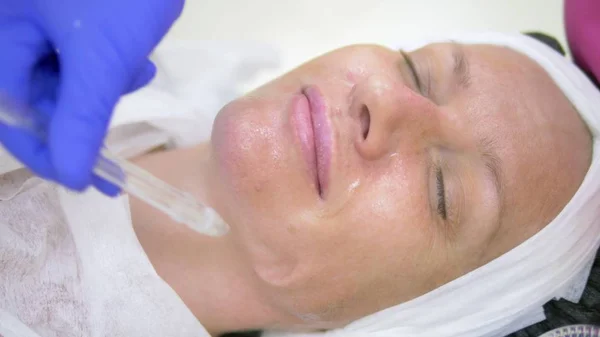 cosmetology concept, face care. woman face during the procedure of jet peeling, facial