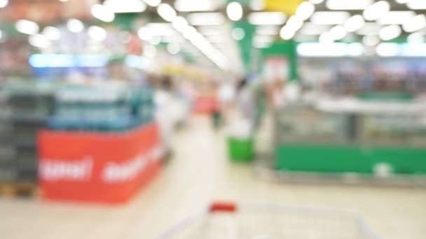 People at the supermarket, blurred background. buyers choose products in the supermarket. — Stock Video