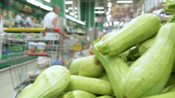 Primer plano. el comprador elige calabacín fresco en el supermercado — Vídeos de Stock