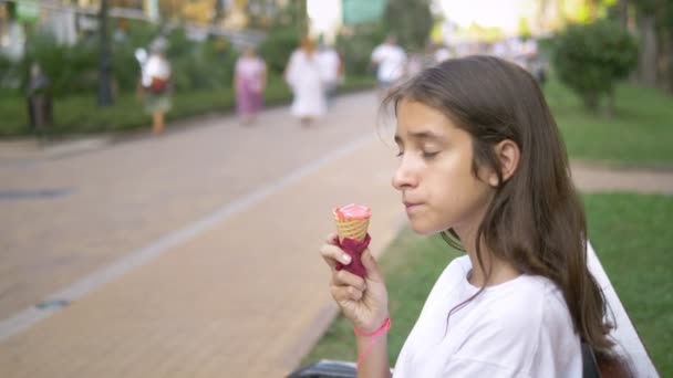 Genç kız açık havada dondurma yiyor. Çocukluk kavramı, yaşam tarzı, gıda, yaz. — Stok video