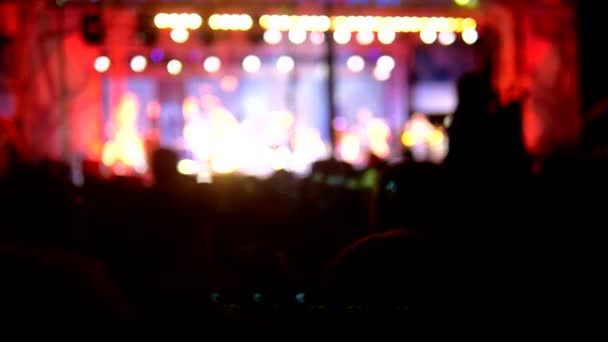 Rock concert in the evening. people in the crowd raise their hands and applaud. — Stock Video