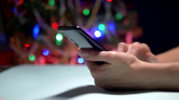 Ευτυχισμένο το νέο έτος και καλά Χριστούγεννα. Γκρο πλαν. γυναικεία χέρια μηνύματα SMS μήνυμα στο smartphone — Αρχείο Βίντεο