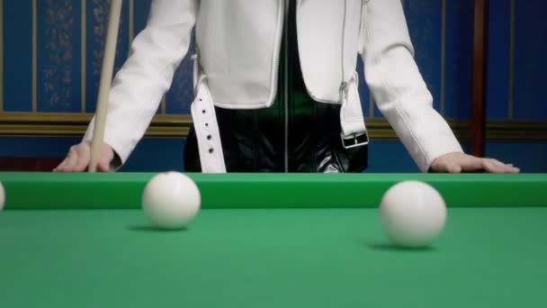 Portrait Beautiful stylish bald girl in a black leather corset and a white jacket next to a pool table. game of billiards. billiards club. — Stock Video