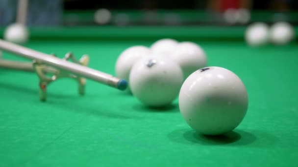 Billiards. Close-up. man hand with cue and white ball on a green pool table. copy space — Stock Video