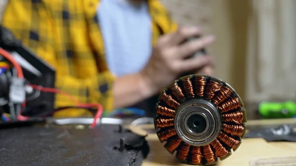 mechanic repairing an electric motor of an electric skate. bearing close up