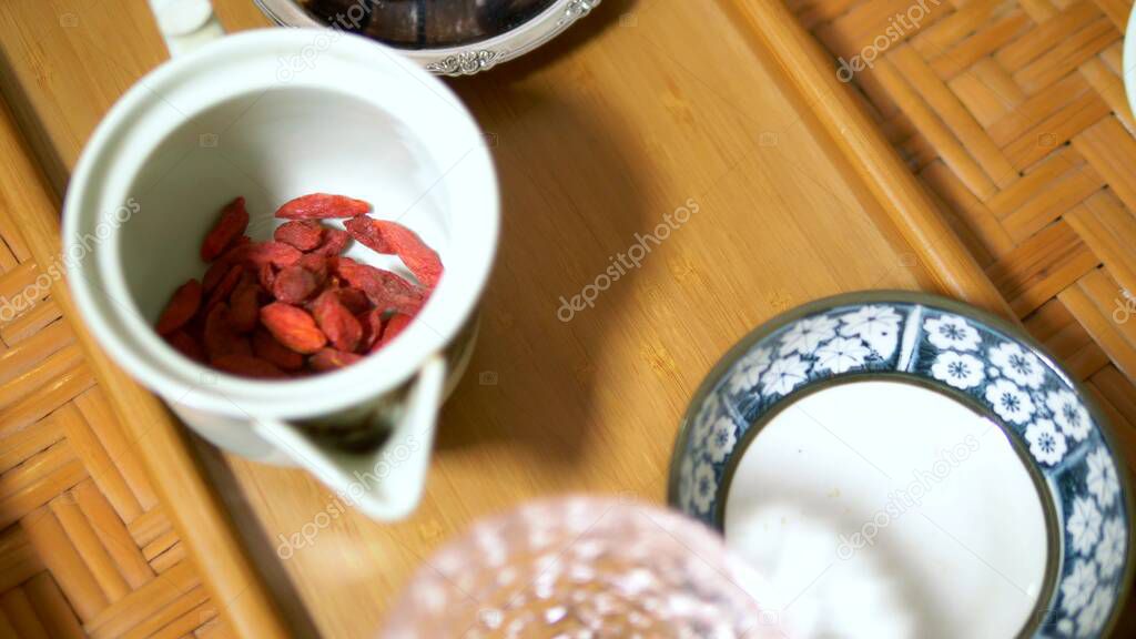 Traditional chinese tea ceremony. Goji berry tea and dessert.