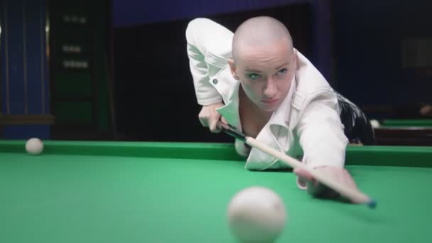 Stílusos kopasz lány egy fehér bőrkabát játszik biliárd. — Stock videók
