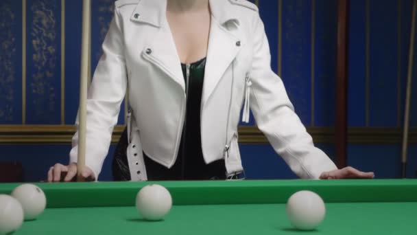 Portrait Beautiful stylish bald girl in a black leather corset and a white jacket next to a pool table. game of billiards. billiards club. — Stock Video