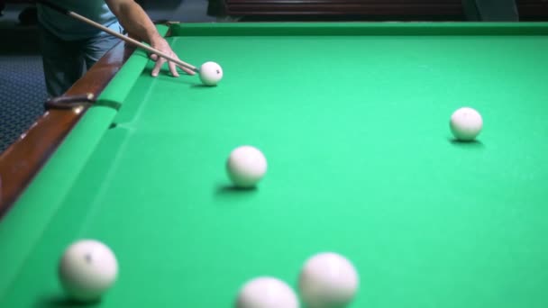 Billiards. Close-up. man hand with cue and white ball on a green pool table. copy space — Stock Video