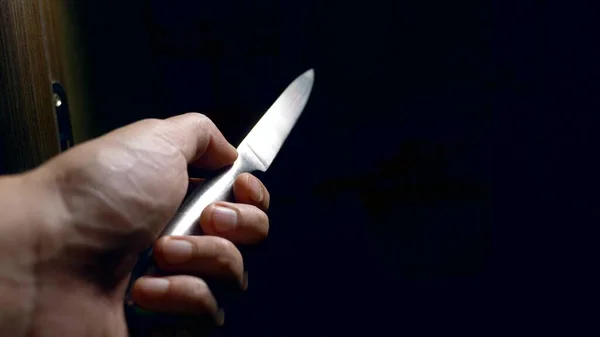 Concept d'Halloween, violence. vue à la première personne. main masculine avec un couteau se déplace le long d'un couloir sombre — Photo