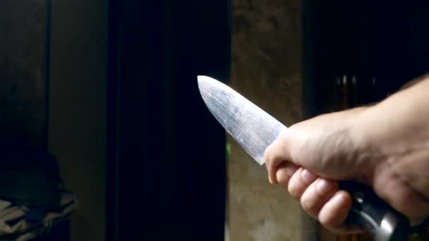 Concept of halloween, violence. first-person view. male hand with a knife moves along a dark corridor — Stock Video