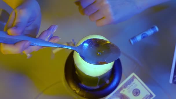 View from above. girl preparing medicine in a spoon over a candle flame, close-up — Stock Video