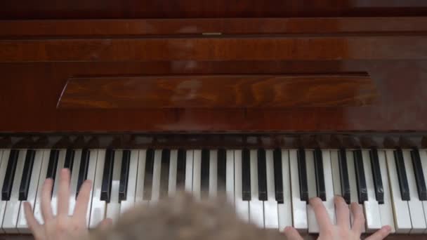 View from above. closeup. female hands masterfully play the piano — Stock Video