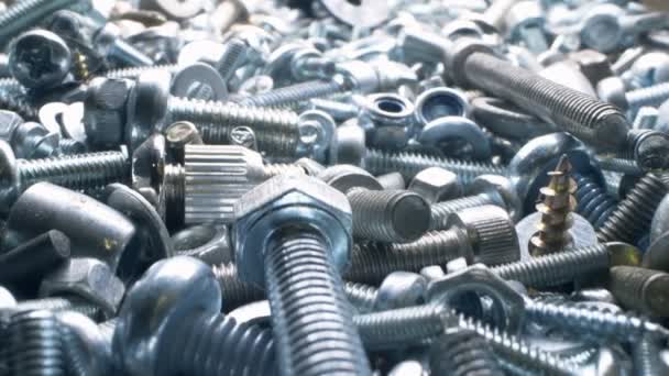 Super close. nut and bolt parts, fasteners in a heap — Stock Video