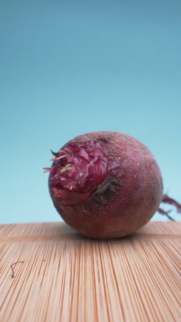 Vertically. super close up. details. fresh beets on a wooden board — Stock Video