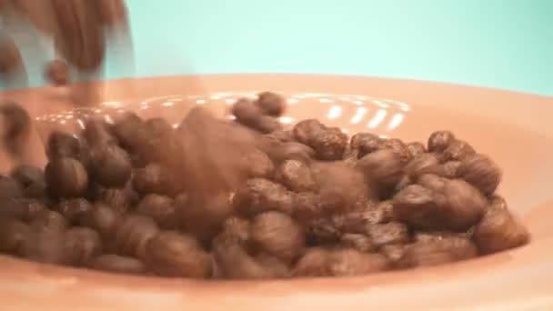 Breakfast cereals in the form of chocolate corn balls sprinkle on a plate — Stock Video