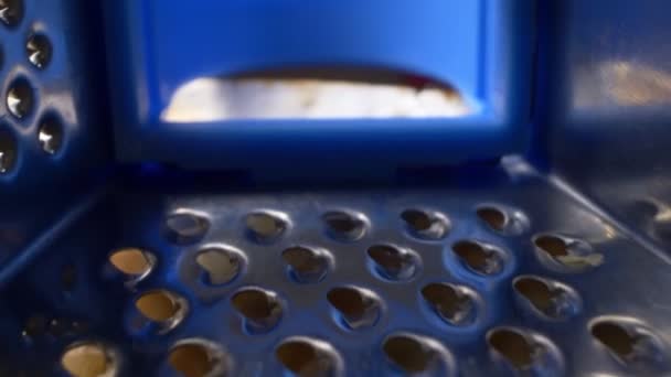 Super close up. grated cheese on an iron grater. cooking process — Stock Video