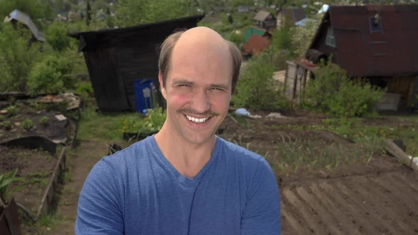 Portrait, balding young man in the countryside looking at the camera, smiling — Stock Photo, Image