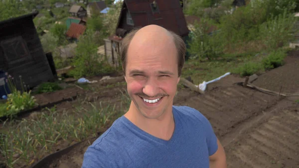 Portrait, balding young man in the countryside looking at the camera, smiling — Stock Photo, Image