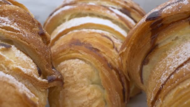 Super close up. details. three croissants with chocolate in a paper bag — Stock Video